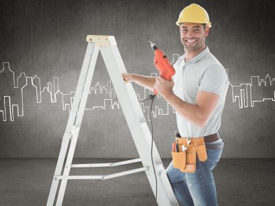 Handyman on ladder against hand drawn city plan